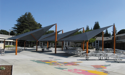 Shade structures for outdoor seating areas
